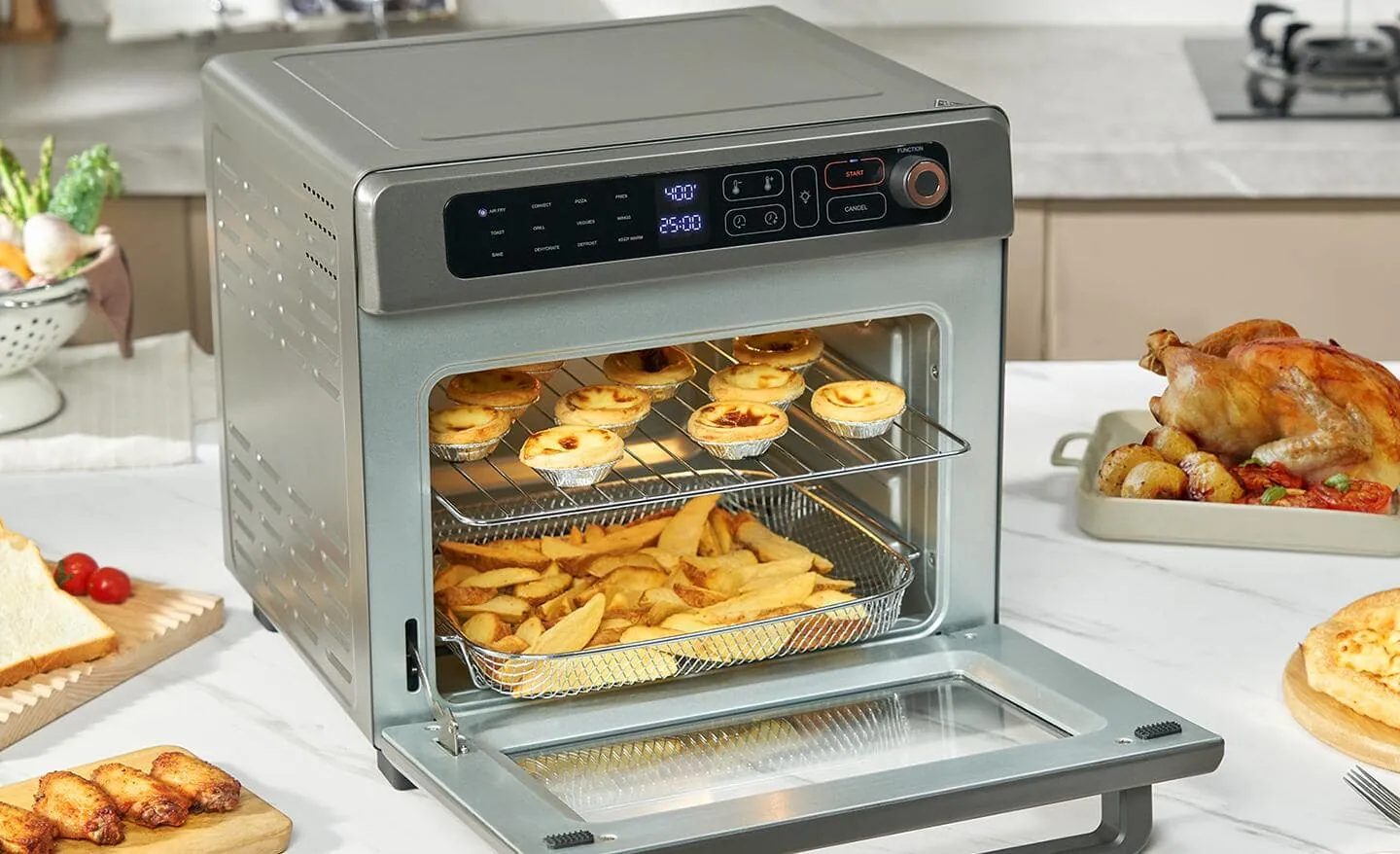Bacon in an air fryer beside roasted chicken in a convection oven.
