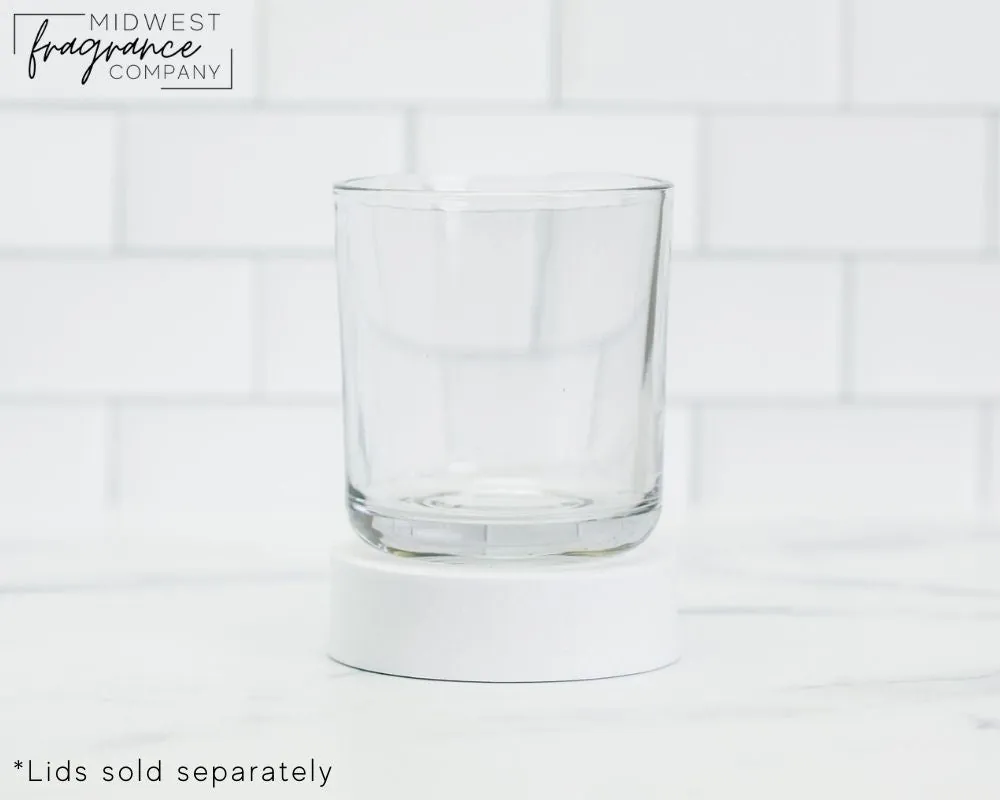 A heat-tempered flat-bottomed tumbler glass filled with steaming hot black coffee.