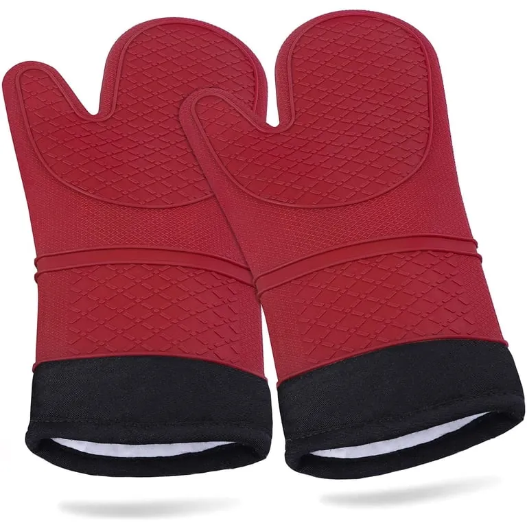 Worn silicone oven gloves on a kitchen counter with a visible damaged area